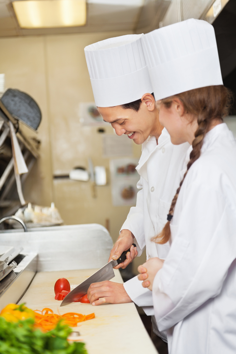 Chef training/teaching assistant to prepare food in commercial restaurant kitchen